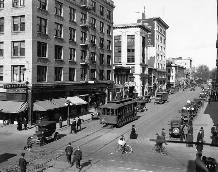 J Street in downtown Sacramento in the early 1900s, with a streetcar and early automobiles